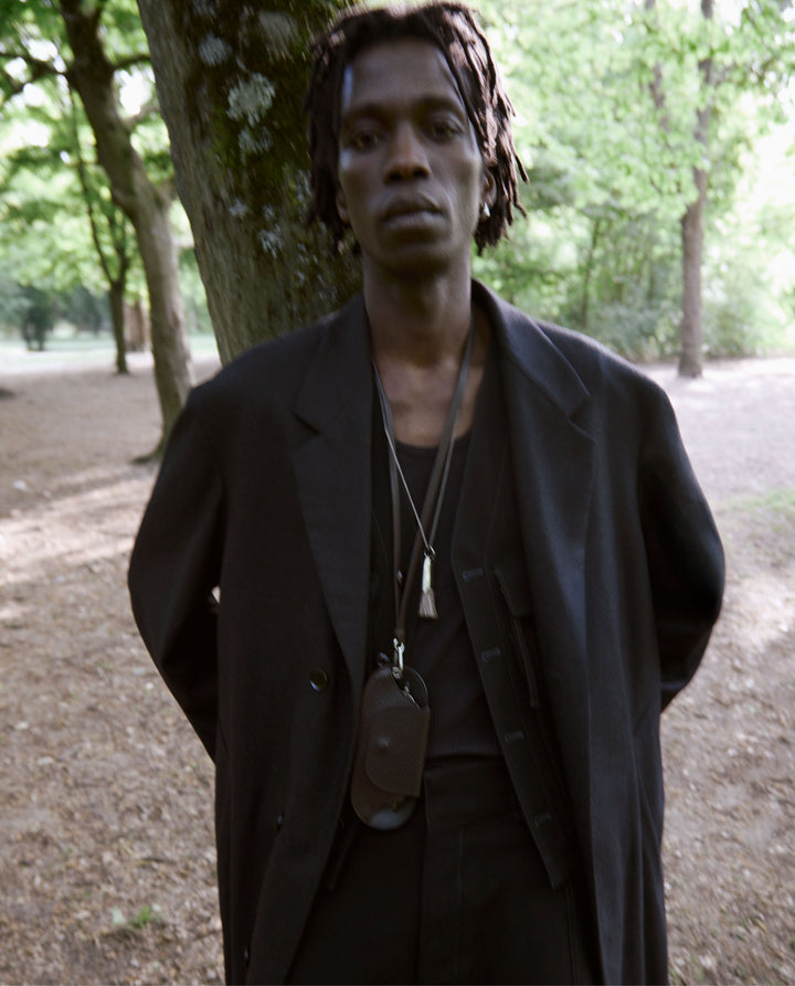 Black coat in black fabric, worn view oversized