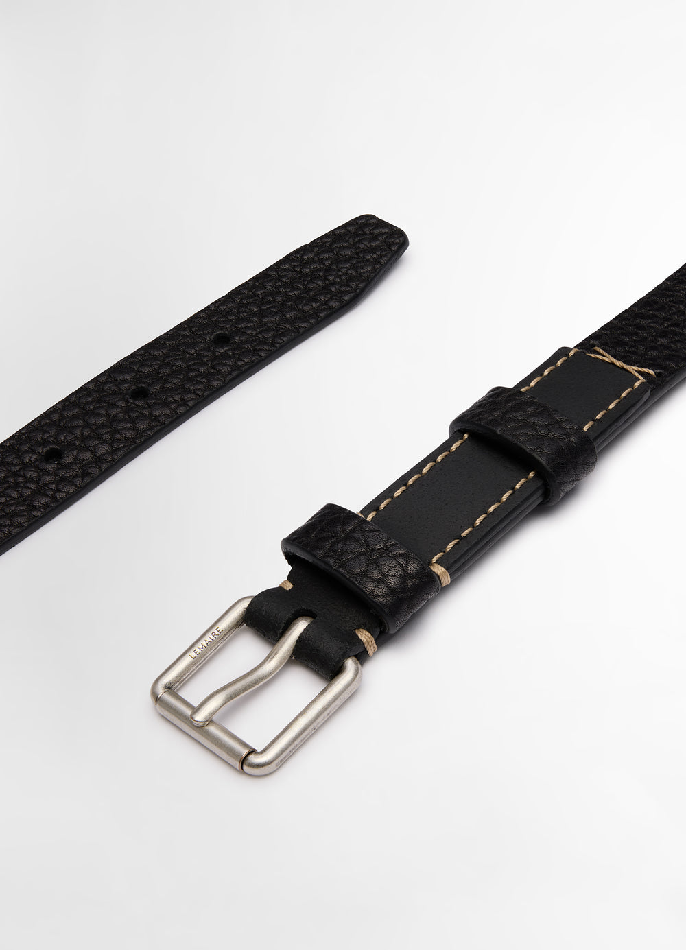 Lemaire Reversed Belt 25 in Black Vegetable-Tanned Leather, product shot, angled detail shot contrasting stitching