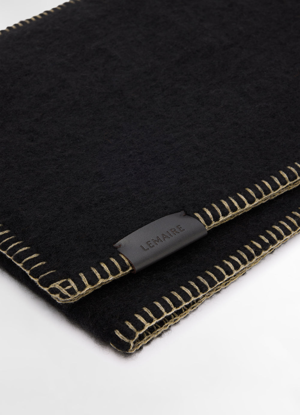 Cocotte Fluffy Scarf in Black Alpaca Wool, product shot, angled close-up stitched leather label