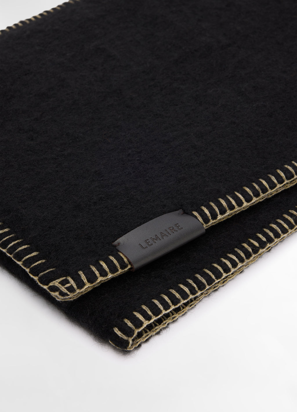 Cocotte Fluffy Scarf in Black Alpaca Wool, product shot, angled close-up stitched leather label