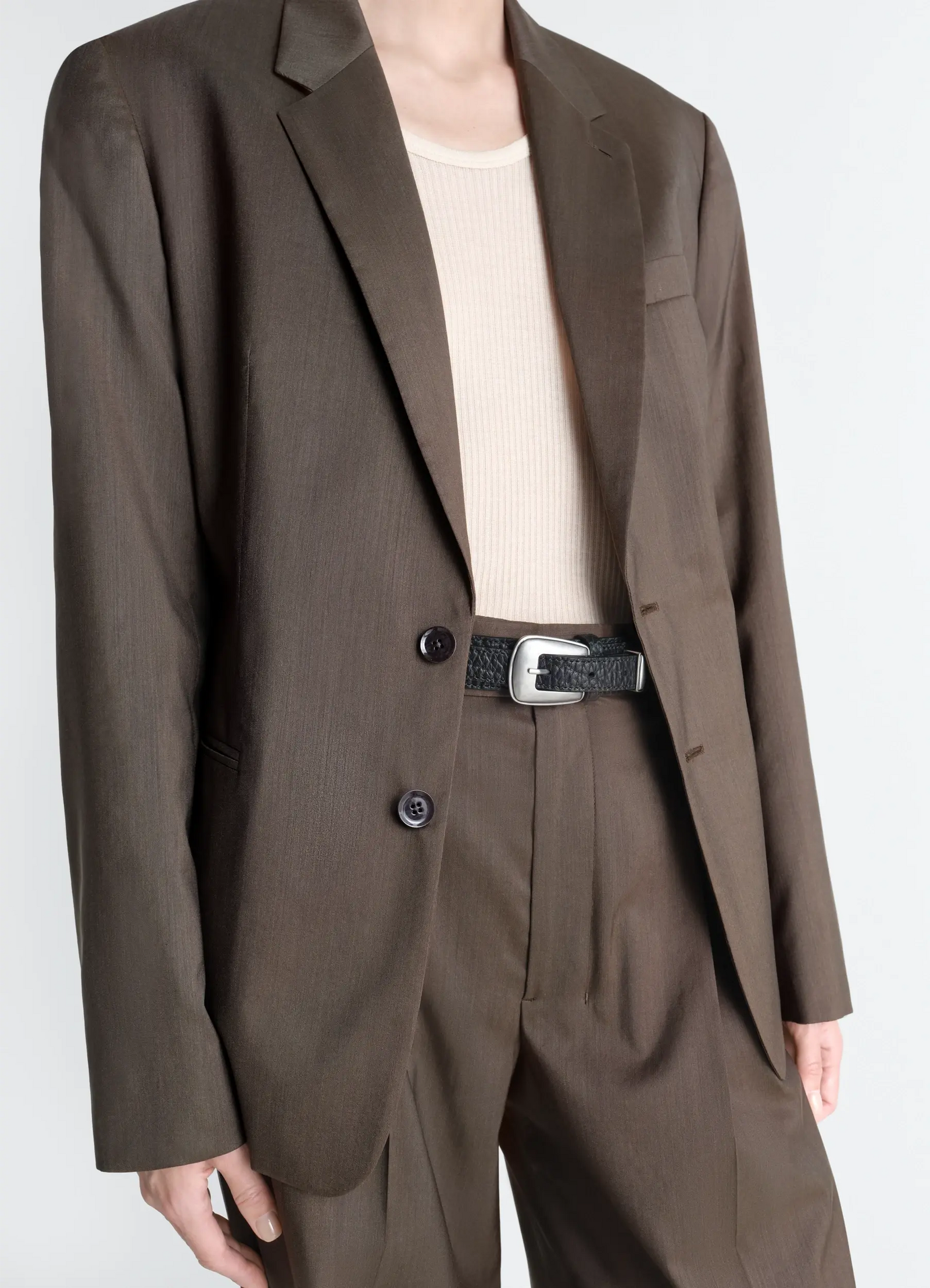 Minimal western belt in grained leather, model shot, worn side view textured leather finish