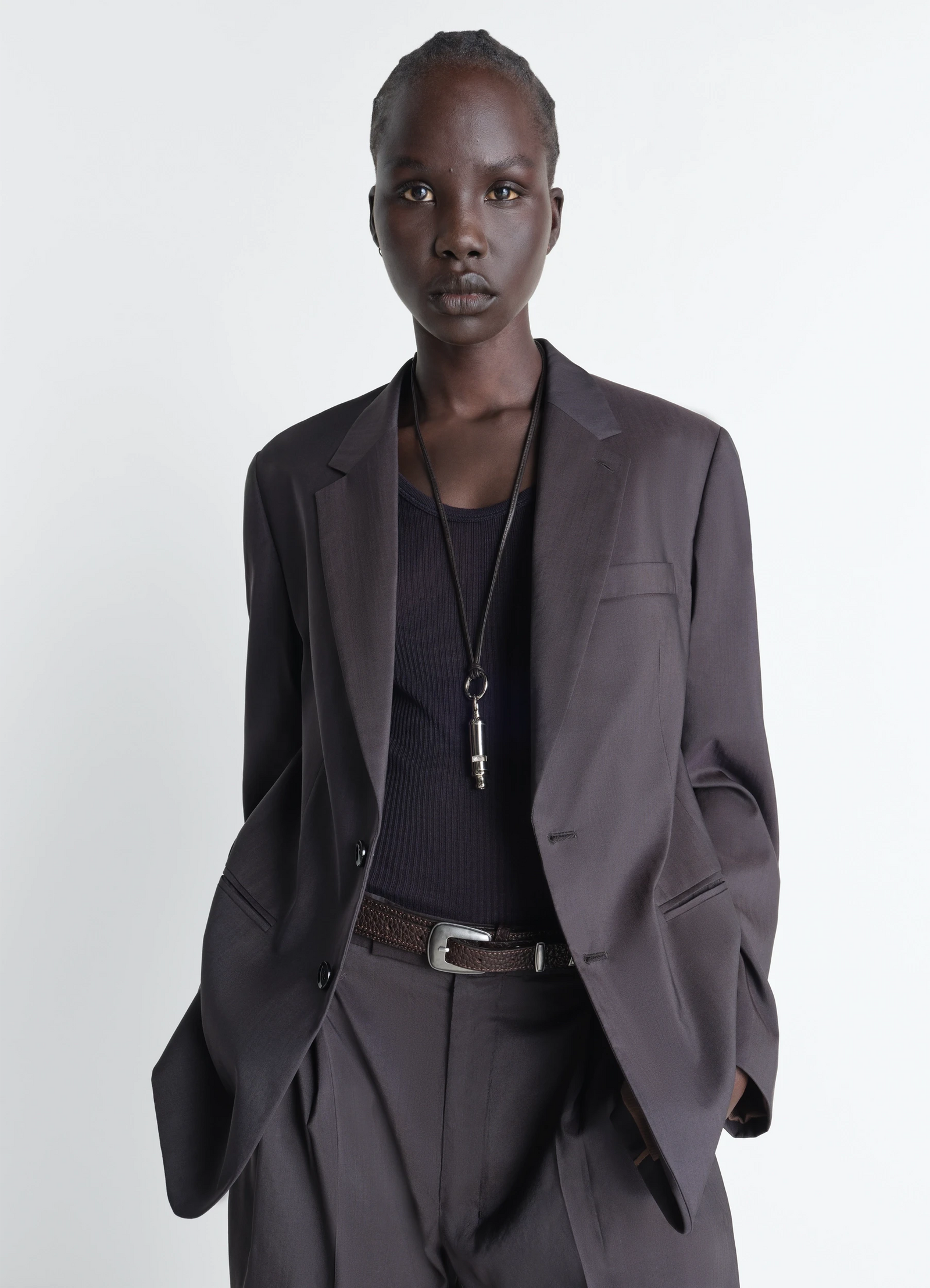 Acme whistle necklace in brass with silver finish, model shot, worn by model paired with blazer