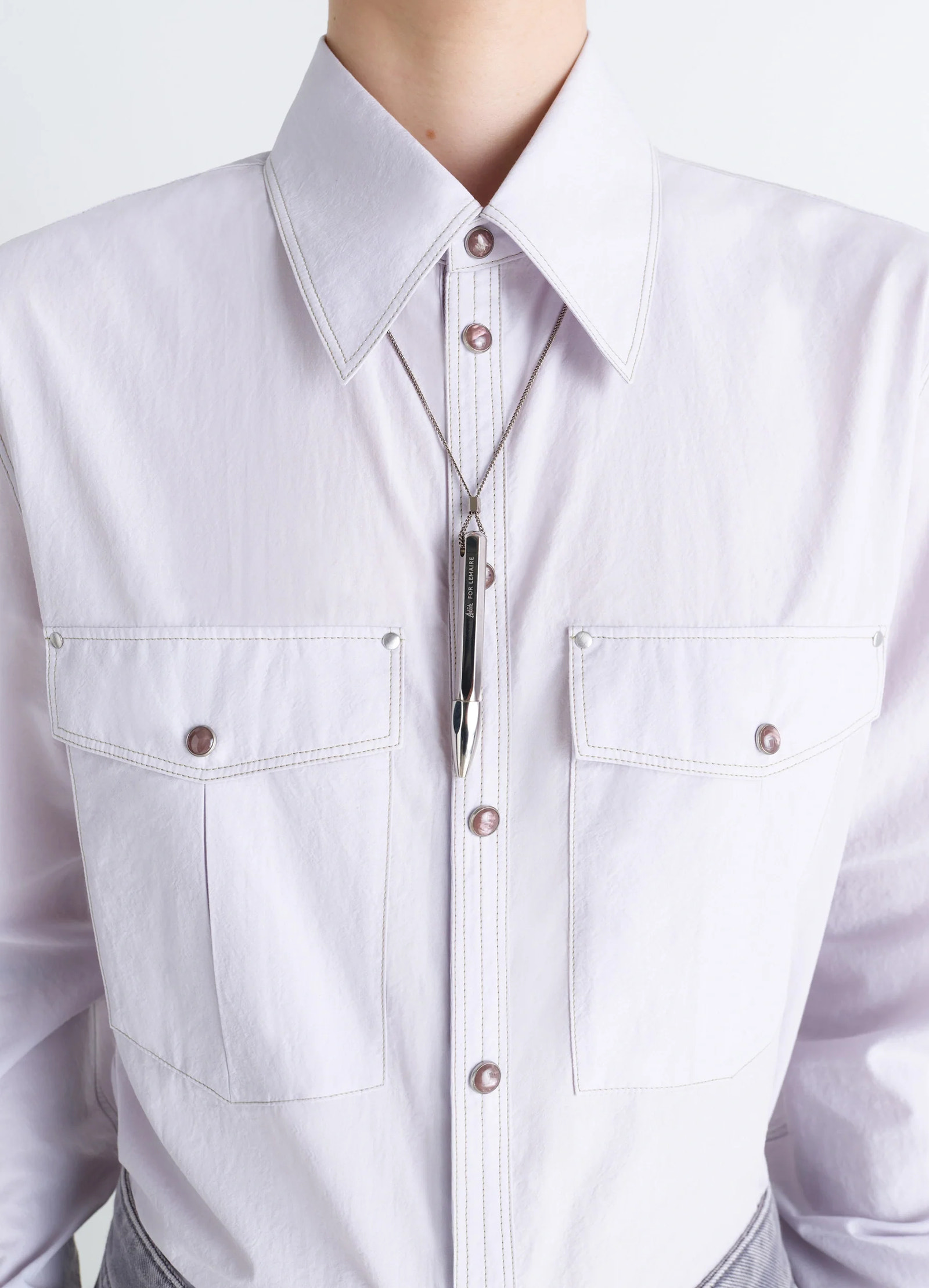 Aubock pen necklace in silver metal, model shot, detail shot worn over shirt