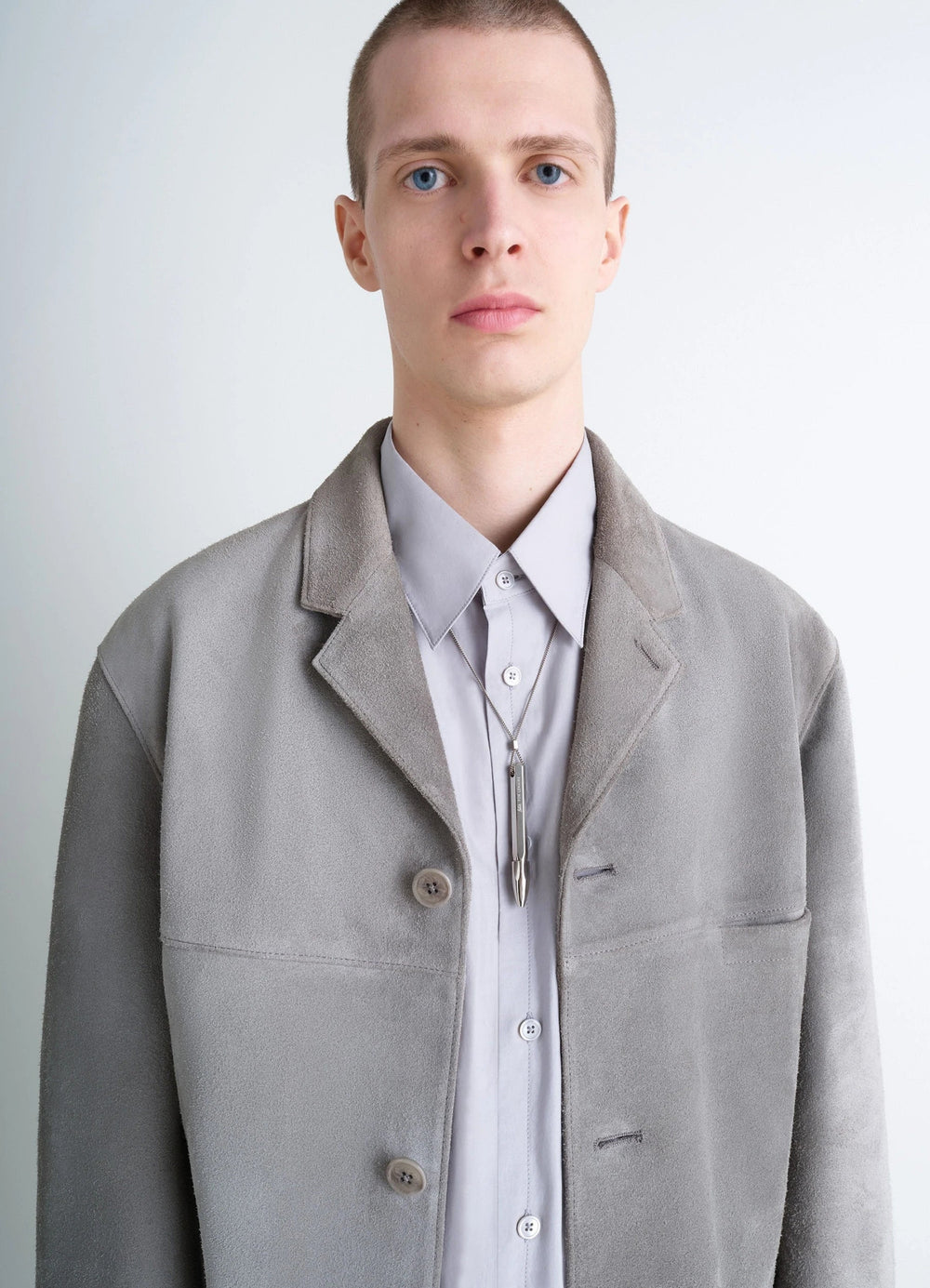 Aubock Pen Necklace in Silver Metal, model shot, front portrait view hung over buttoned shirt