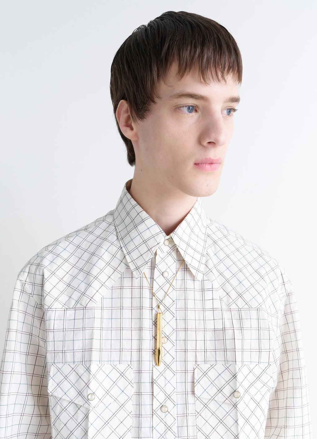 AUBOCK Pen Necklace in Gold Tone Metal, model shot, side profile view geometric pattern shirt