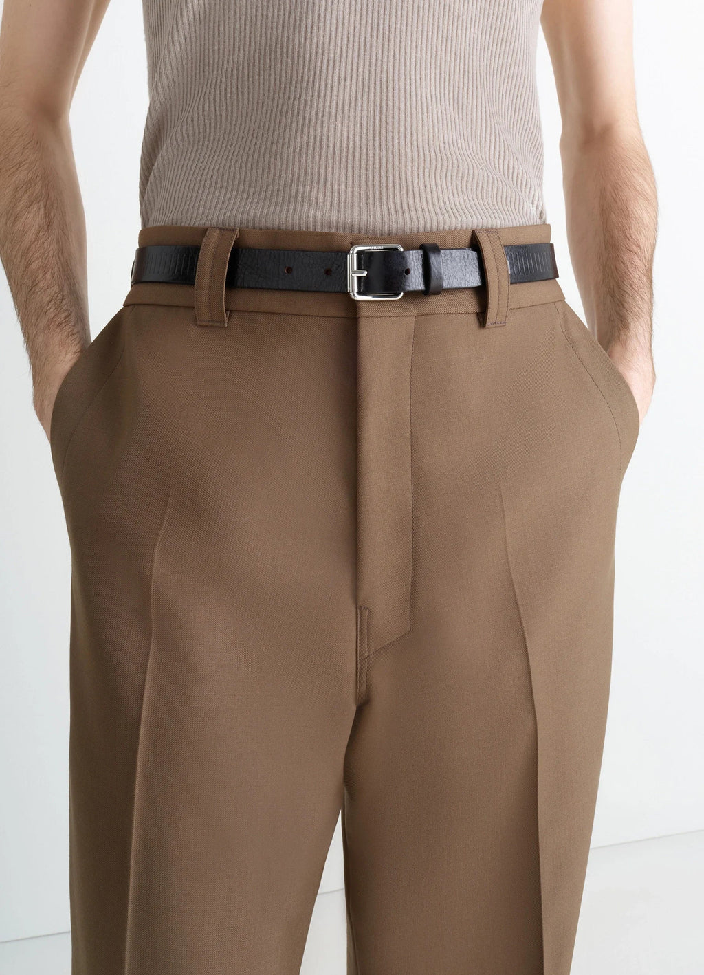 Rail Belt 25 in rail-embossed leather, model shot, wearing close-up textured pattern