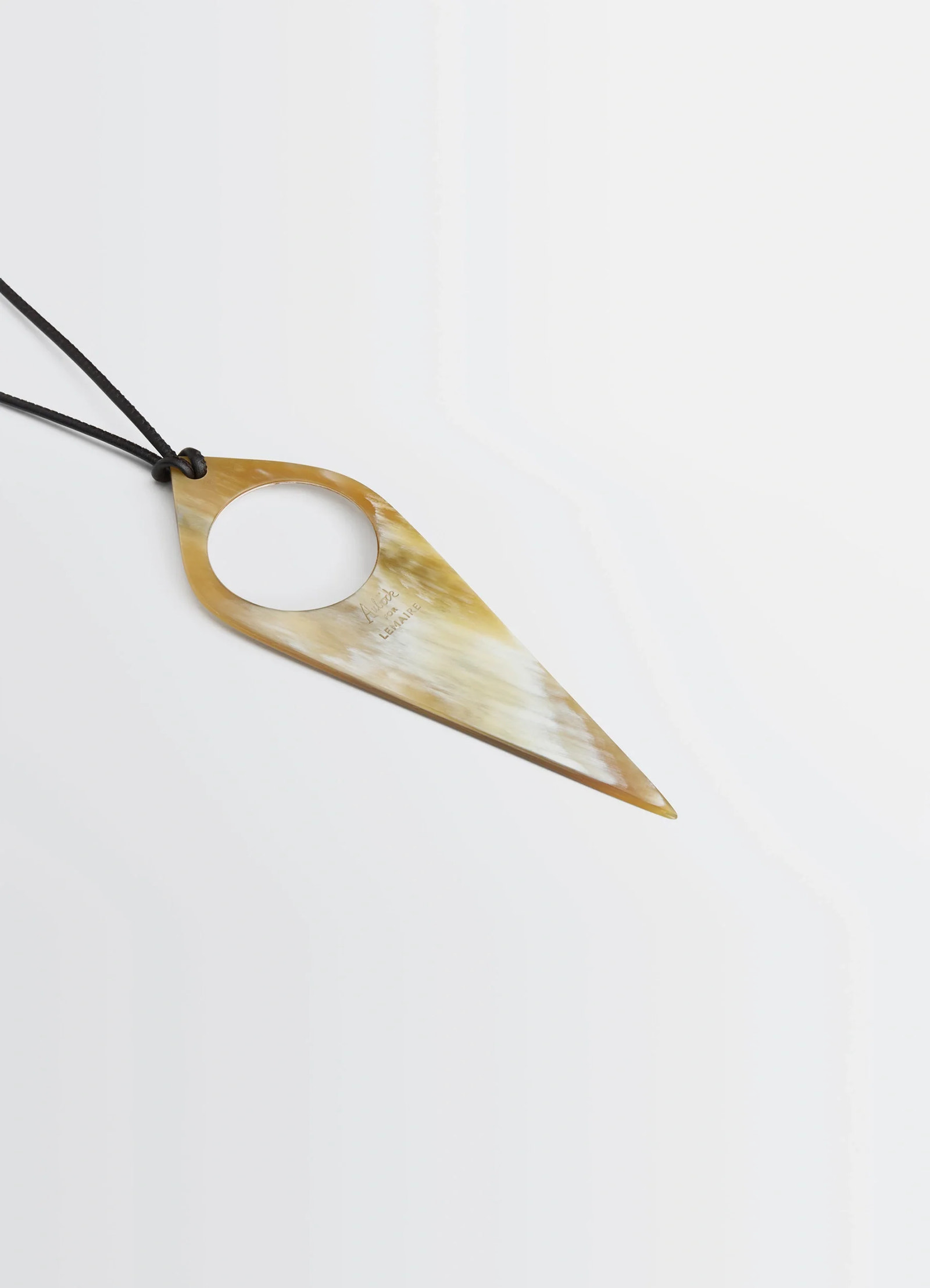 Aubock magnifying glass necklace in horn, product shot, diagonal close-up detailed horn texture