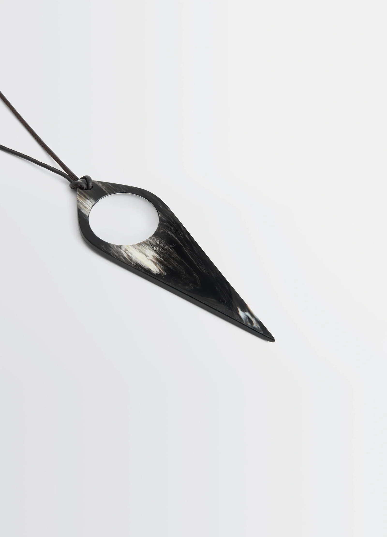 Aubock magnifying glass necklace in horn, product shot, angled perspective pointed design, glossy finish