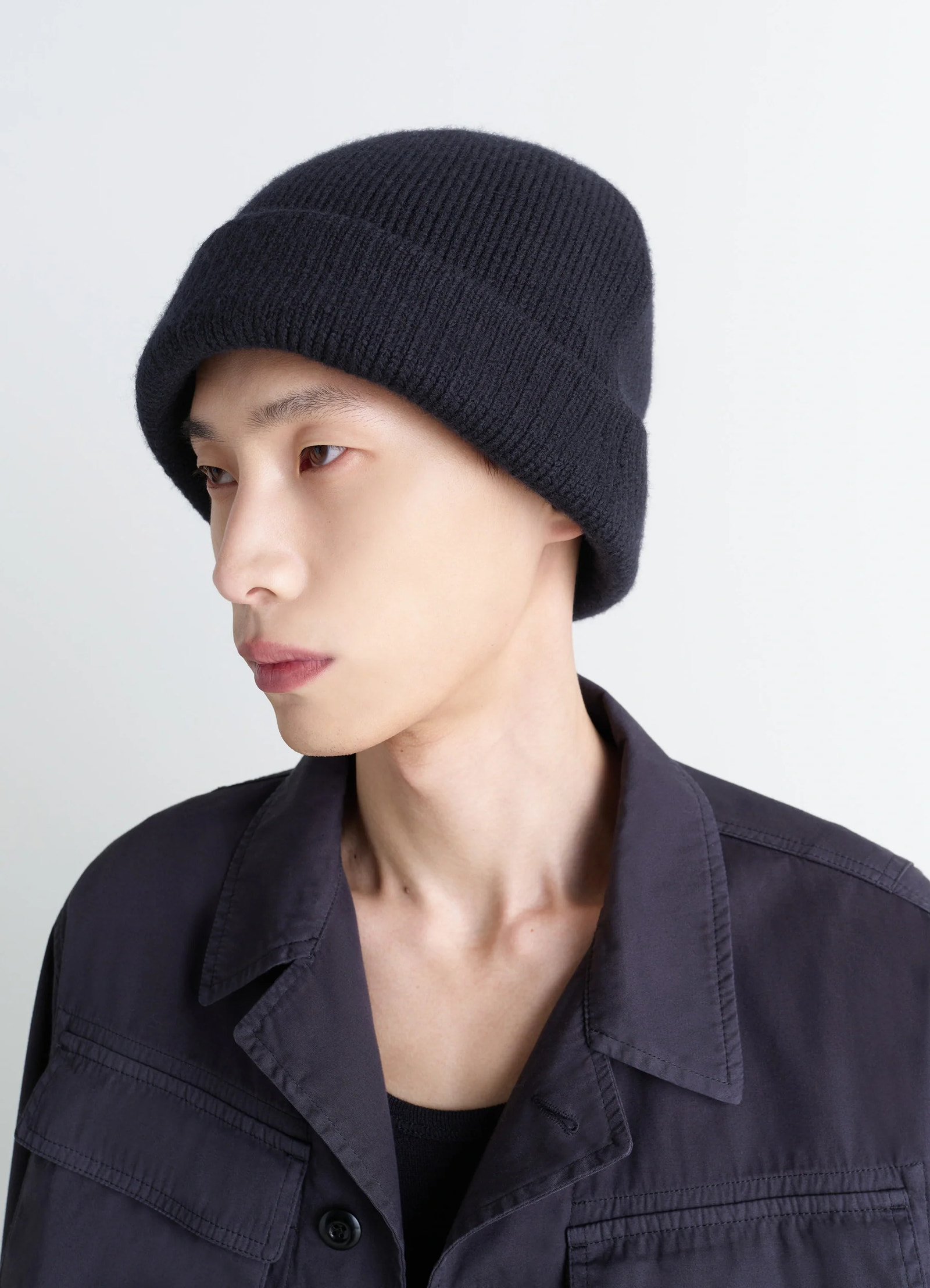 Knitted wool blend beanie in heather black wool blend, model shot, side view dense double-faced texture
