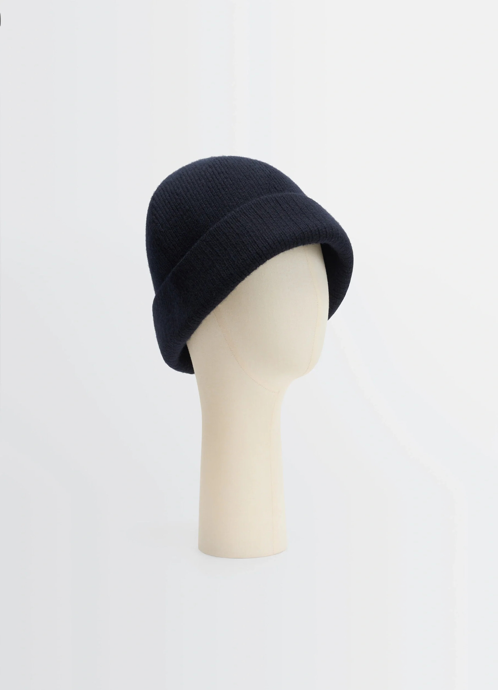 Knitted wool blend beanie in heather black wool blend, product shot, three-quarter view rolled cuff design
