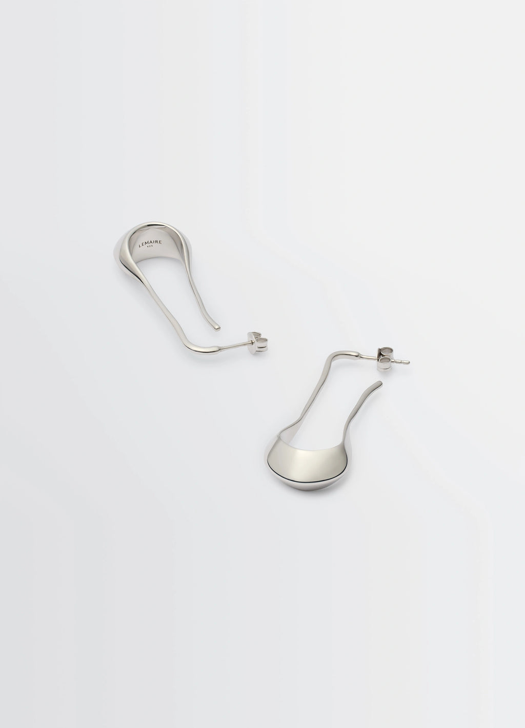 Lemaire Signature Drop Earrings in Rhodium-plated Silver, product shot, angled view asymmetric drop shape