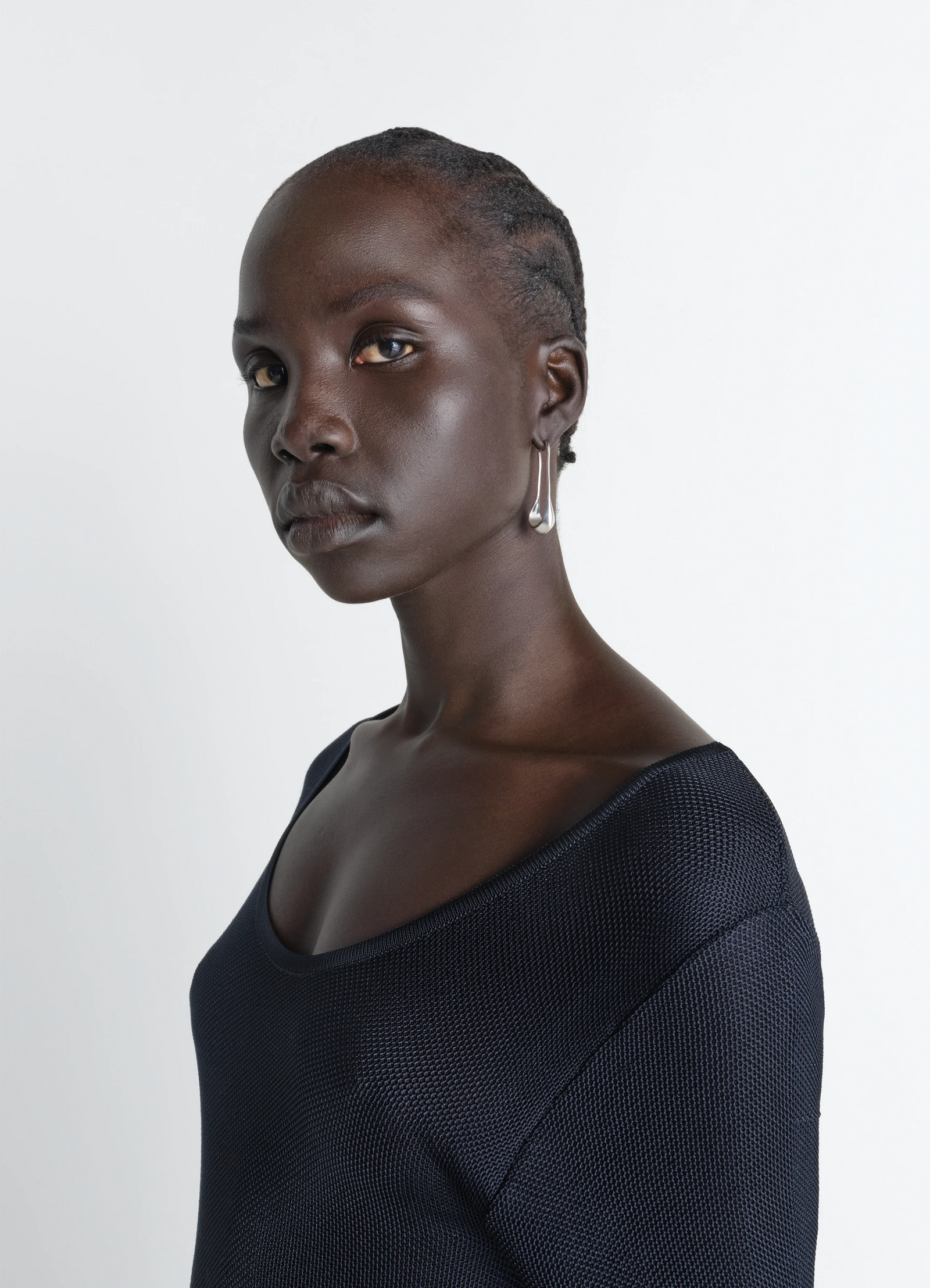 Lemaire short drop earrings in rhodium-plated silver, model shot, side view worn by model