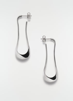 Short silver drop earrings in polished metal by lemaire on plain white background front view