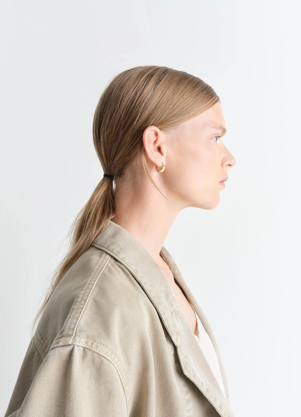 Lemaire Mini Drop Earring in Vermeil, model shot, profile view worn with hair in ponytail