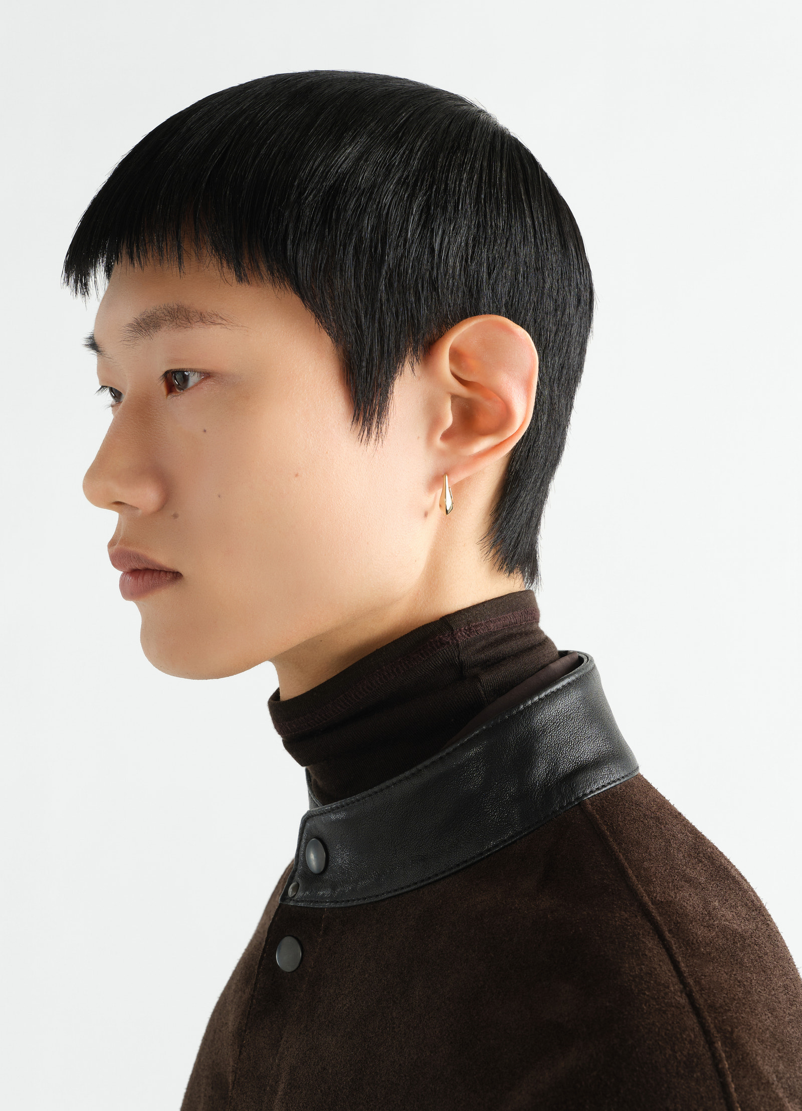 Mini drop earring in vermeil lemaire worn by a model side view with black hair and brown jacket collar detail