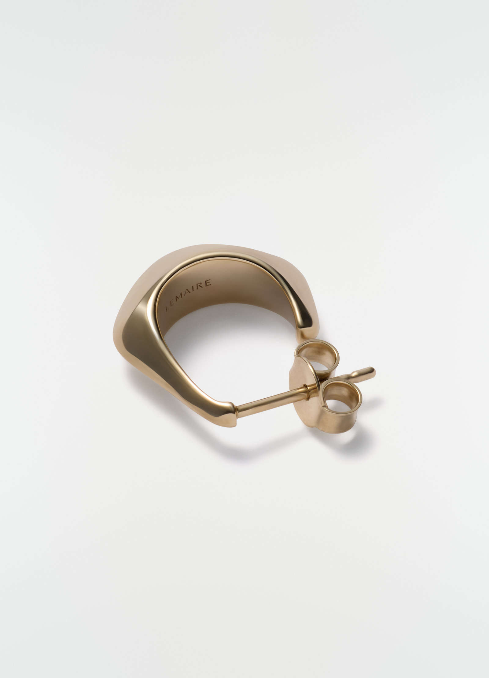 Mini drop earring in gold vermeil metal by lemaire close-up on plain white background showing post and back closure