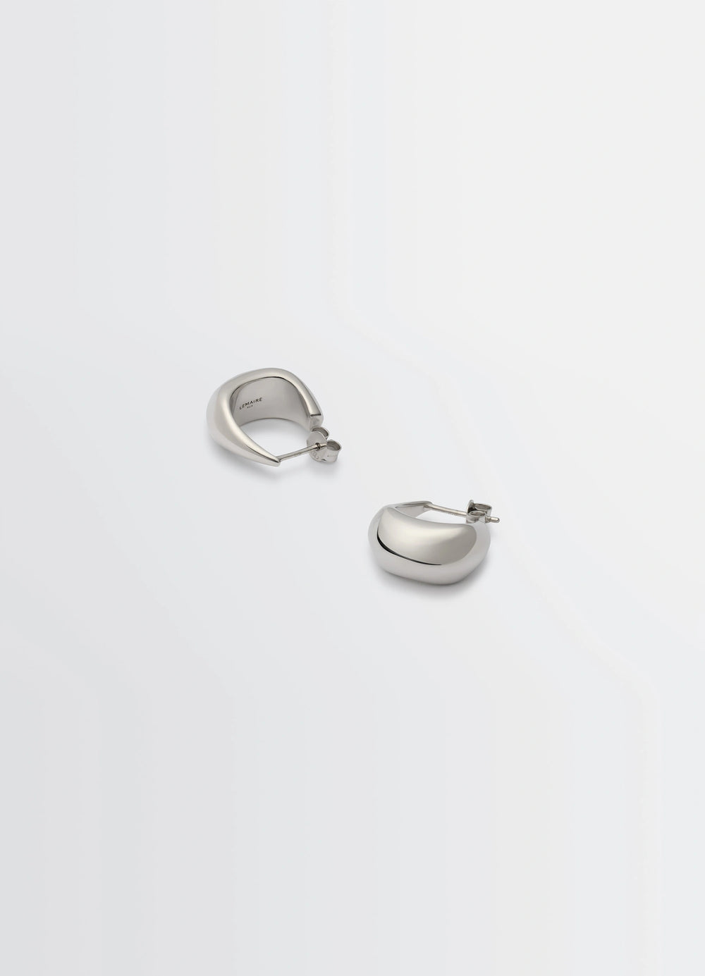 Lemaire Curved Mini Drop Earrings in Rhodium-Plated Silver, product shot, top angle curved drop shape
