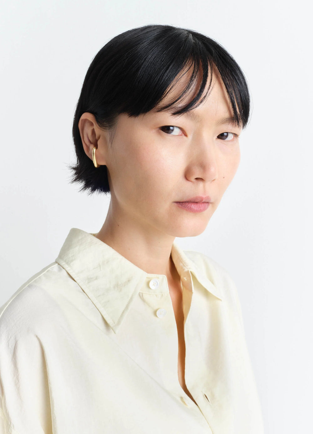 Lemaire Long Drop Earcuff in Vermeil, model shot, three-quarter view elegant curved design