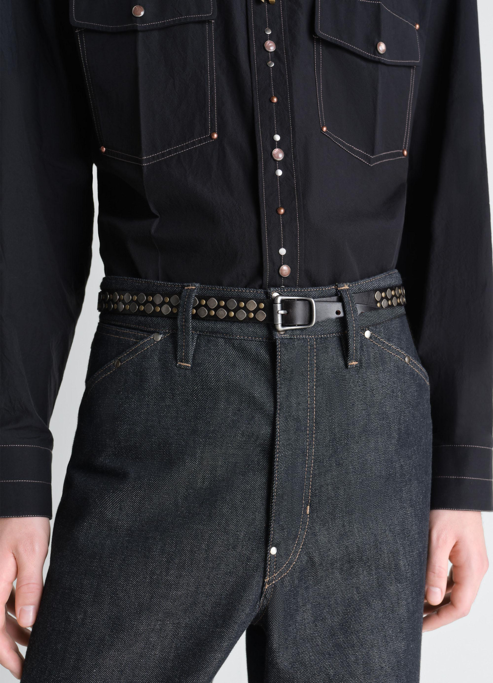 Rio studs belt 20 mm in leather, model shot, waist-level side view paired with denim jeans