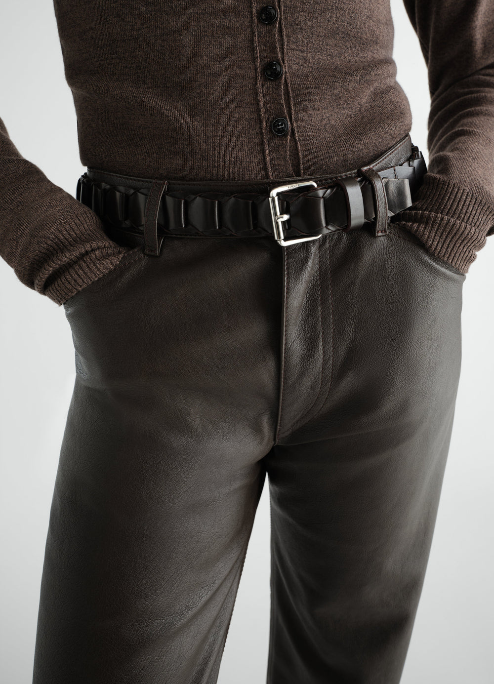 Link belt in black vegetable-tanned leather with silver buckle worn by a model LEMAIRE close-up detail