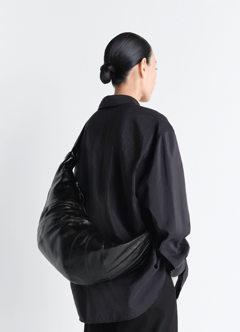 Large Croissant Bag in Coated Cotton, model shot, back view sleek with draped effect