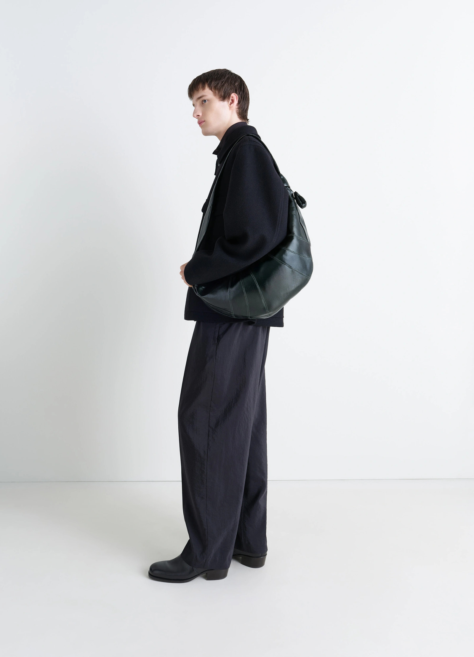 Lemaire large croissant bag in coated cotton canvas, model shot, three-quarter view slouchy draped effect