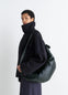 Lemaire Large Croissant Bag in Coated Cotton Canvas, model shot, Side view Curved silhouette