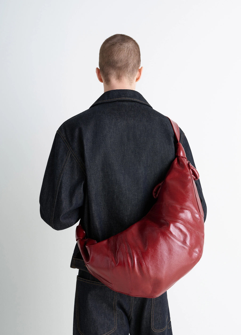 Lemaire Large Croissant Bag in Red coated cotton canvas, model shot, back view supple curved shape