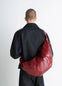 Lemaire Large Croissant Bag in Red coated cotton canvas, model shot, back view supple curved shape