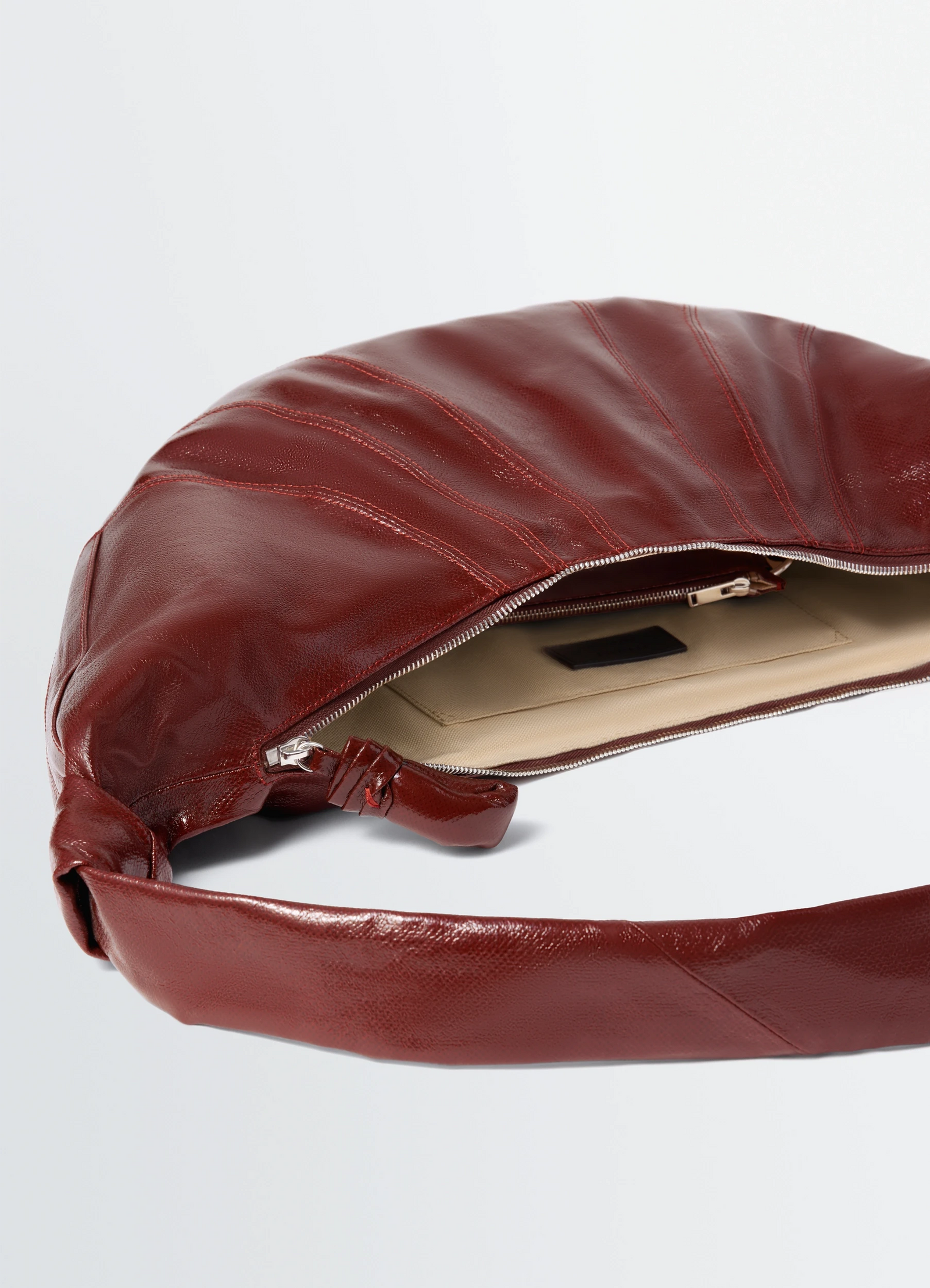 Large croissant bag in coated cotton canvas, product shot, top detail shot visible zipper opening