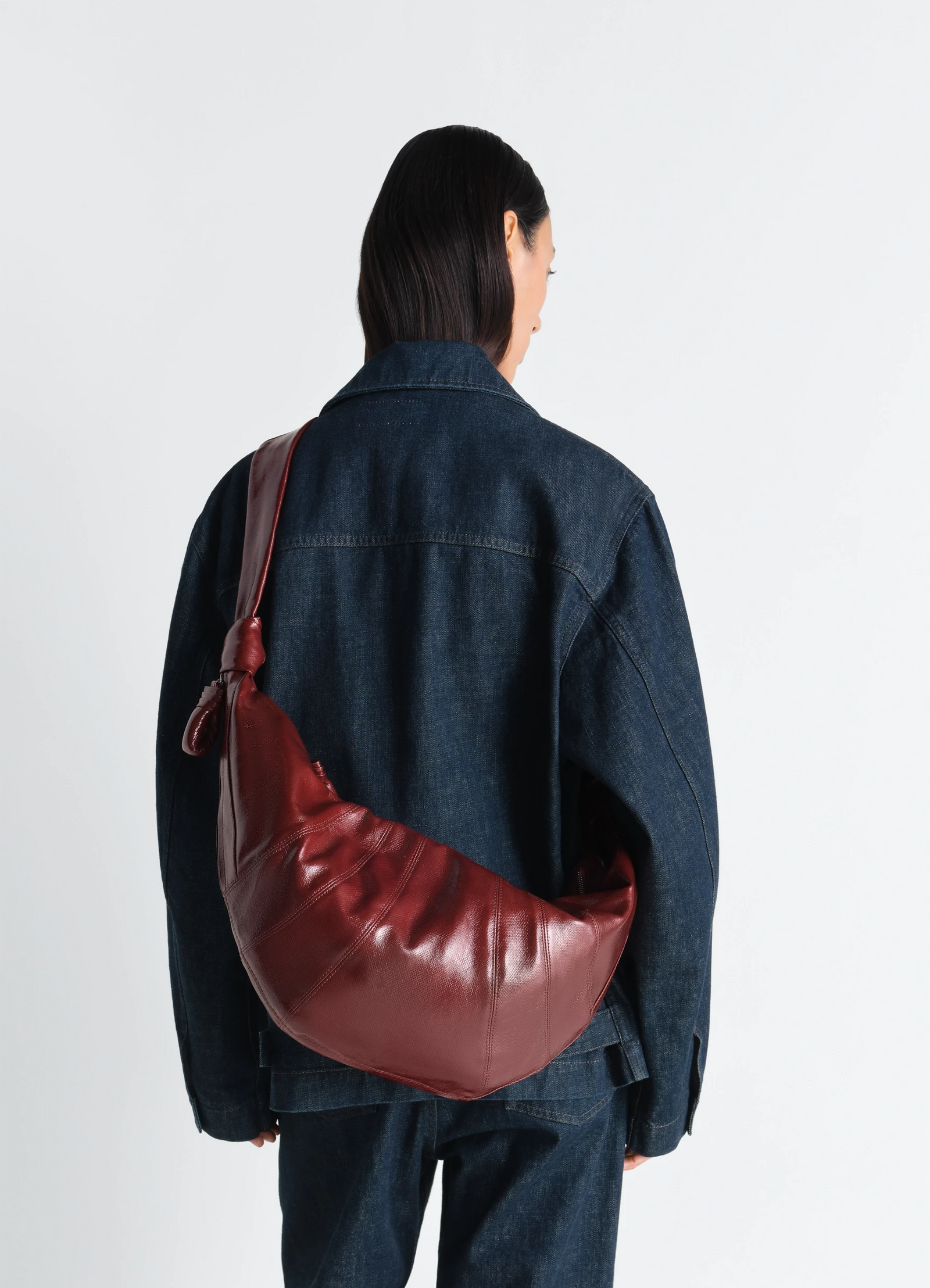 Large croissant bag in coated cotton canvas, model shot, back view worn over shoulder