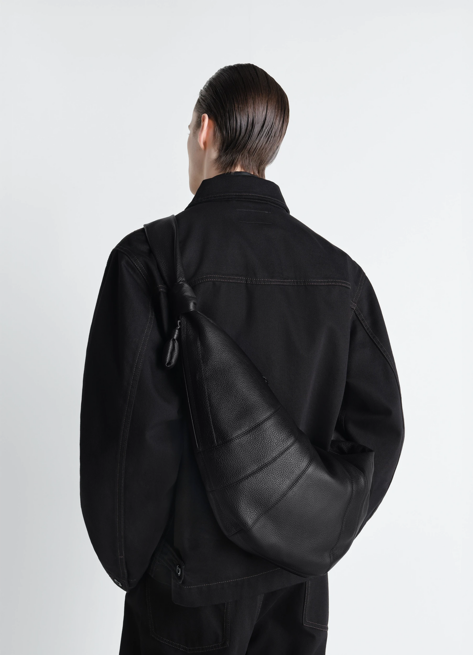 Lemaire large croissant bag in grained leather, model shot, back view slouchy silhouette