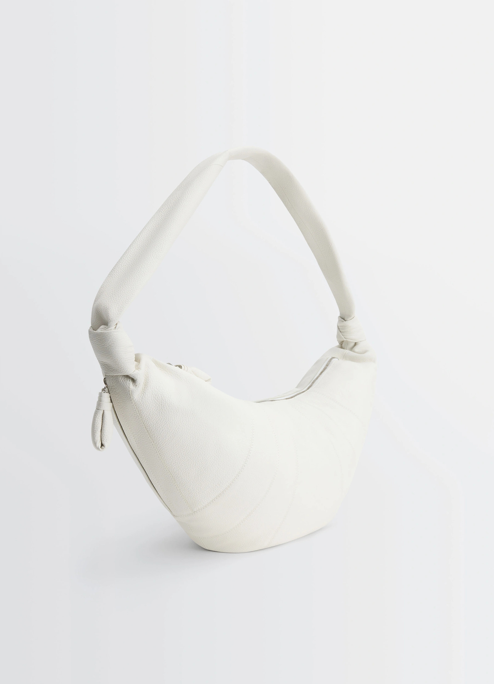 Lemaire large croissant bag in soft grained leather, product shot, angled side view minimal texture detail