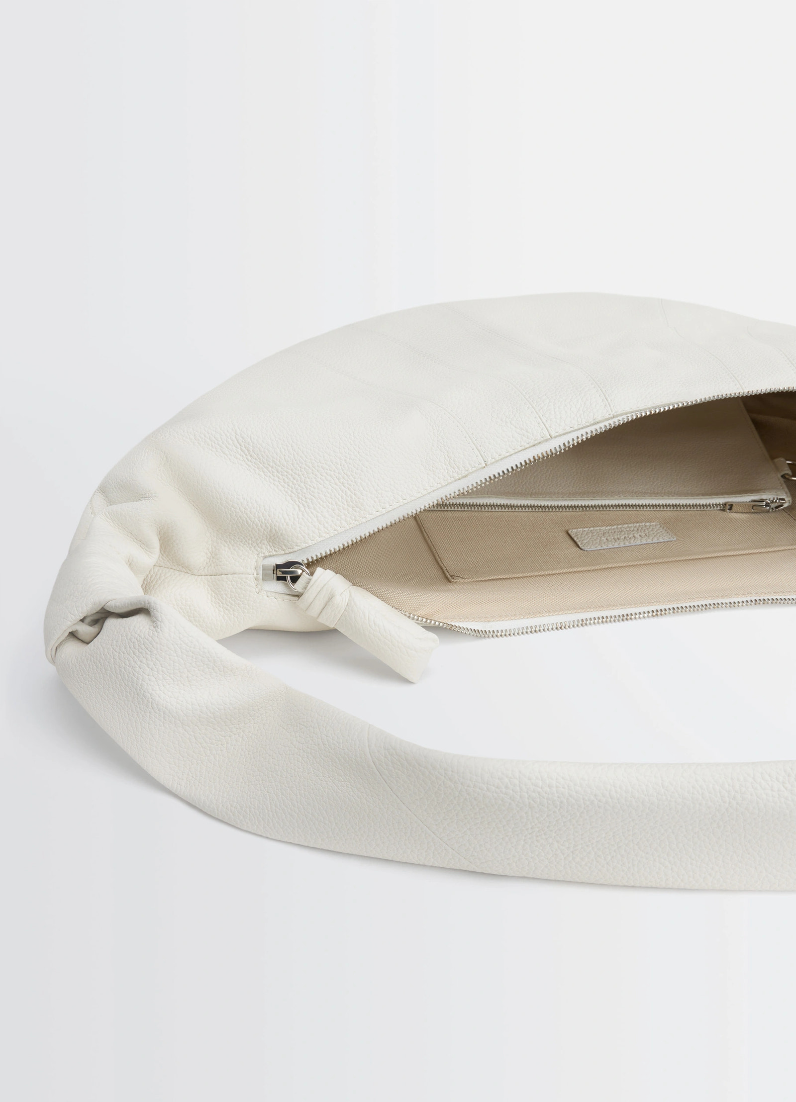Lemaire large croissant bag in soft grained leather, product shot, open zipper detail exposed interior pocket