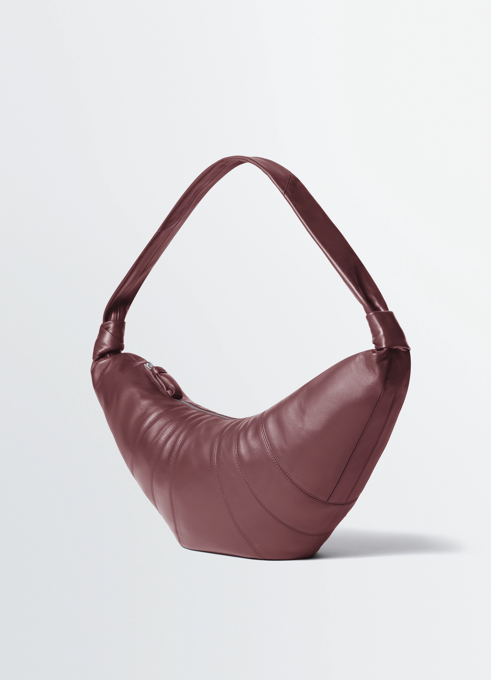 Lemaire large croissant bag in nappa lamb leather, product shot, side view arched top handle