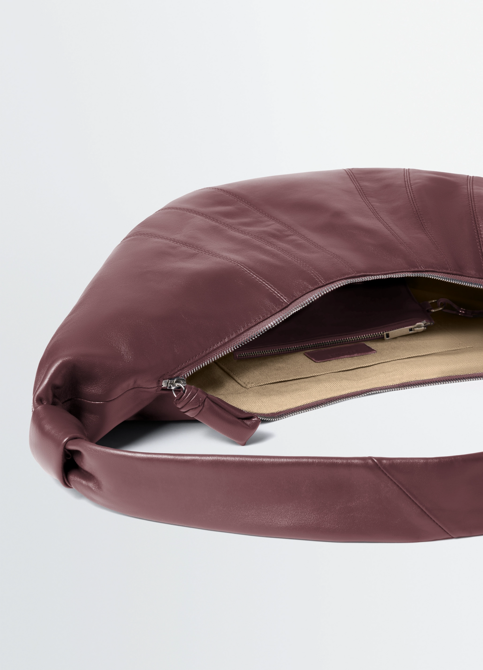 Lemaire large croissant bag in nappa lamb leather, product shot, interior angle detail exposed zipper open view