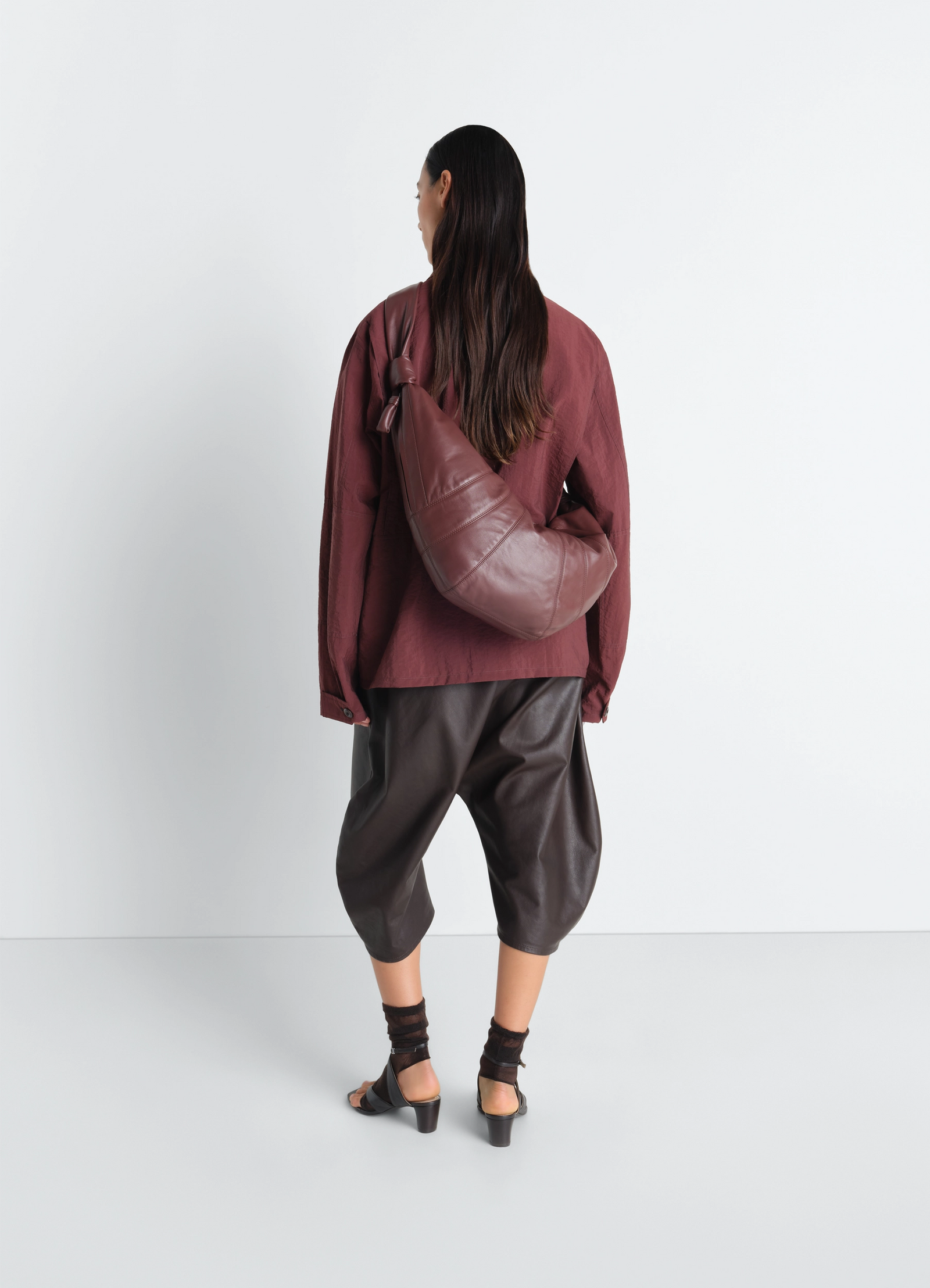 Lemaire large croissant bag in nappa lamb leather, model shot, back view worn over shoulder