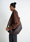 Lemaire Large Croissant Bag in Nappa Lamb Leather, model shot, Side view Supple, topstitched panels