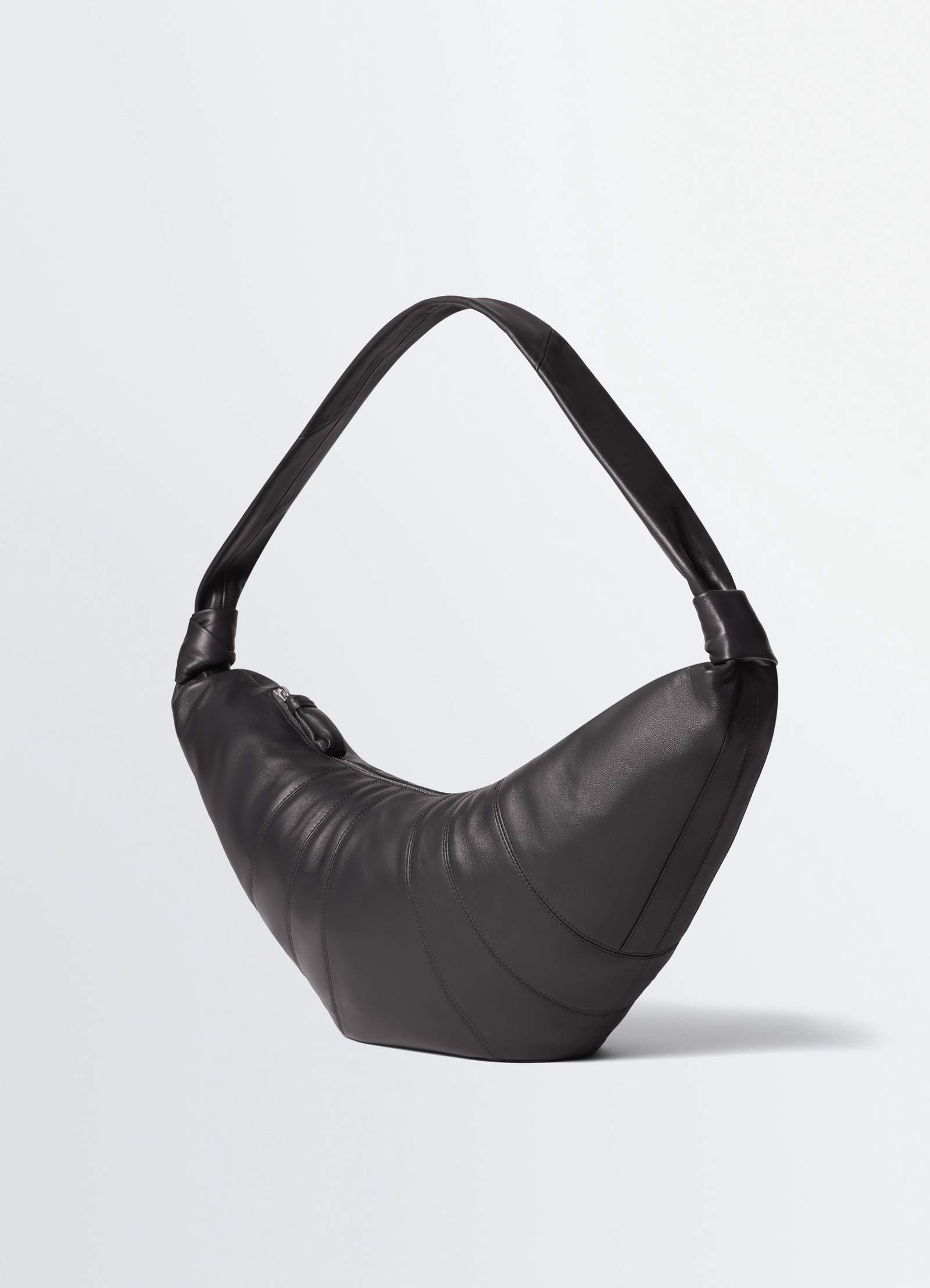 Lemaire large croissant bag in nappa lamb leather, product shot, side view curved strap, top zip