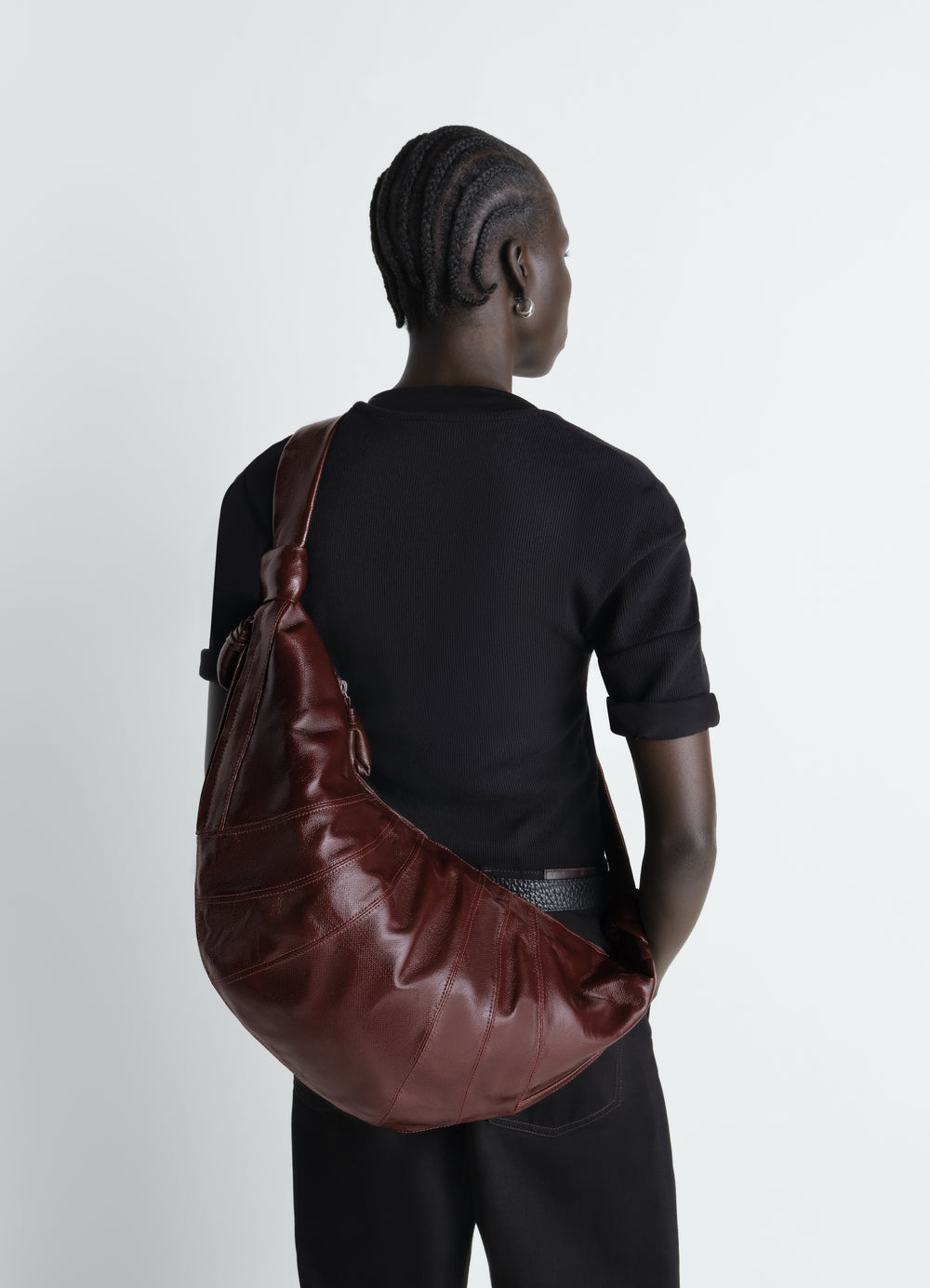 Lemaire Large Croissant Bag in Coated Cotton, model shot, back view draped over shoulder