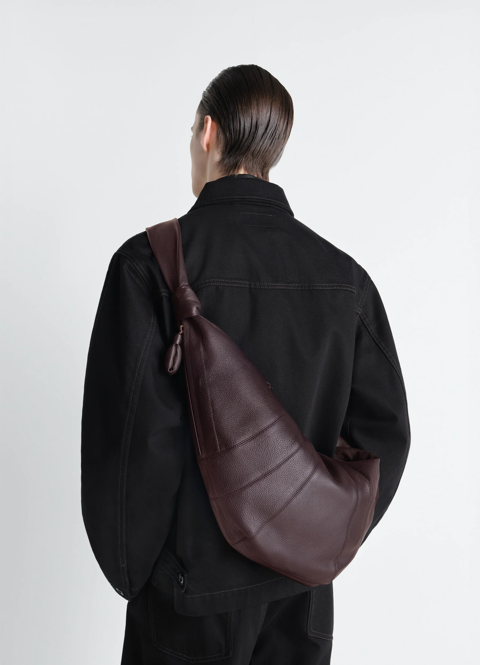 Lemaire large croissant bag in grained leather, model shot, back view slung over shoulder