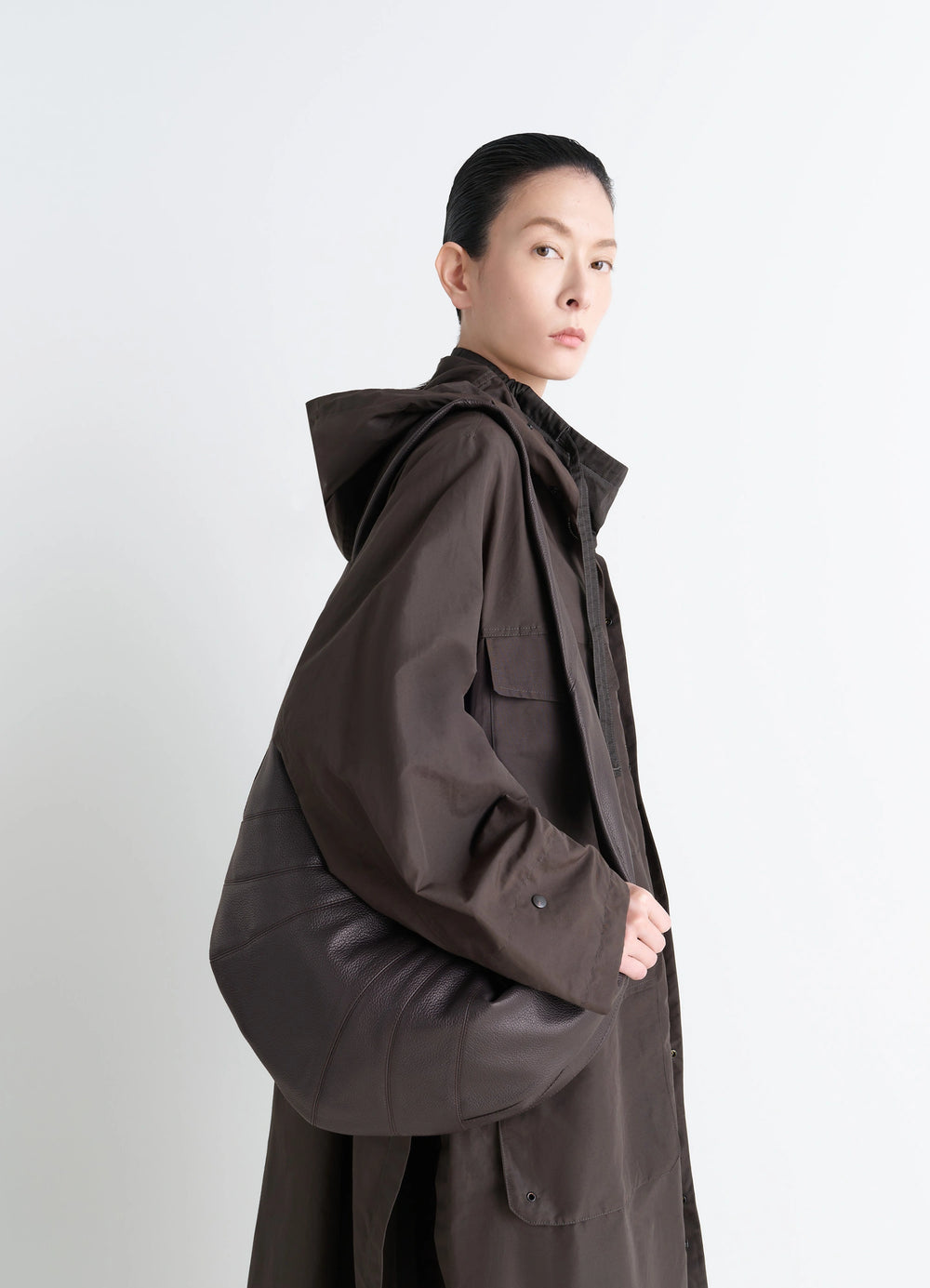 Lemaire Large Croissant Bag in Grained Leather, model shot, three-quarter view slouchy underarm carry