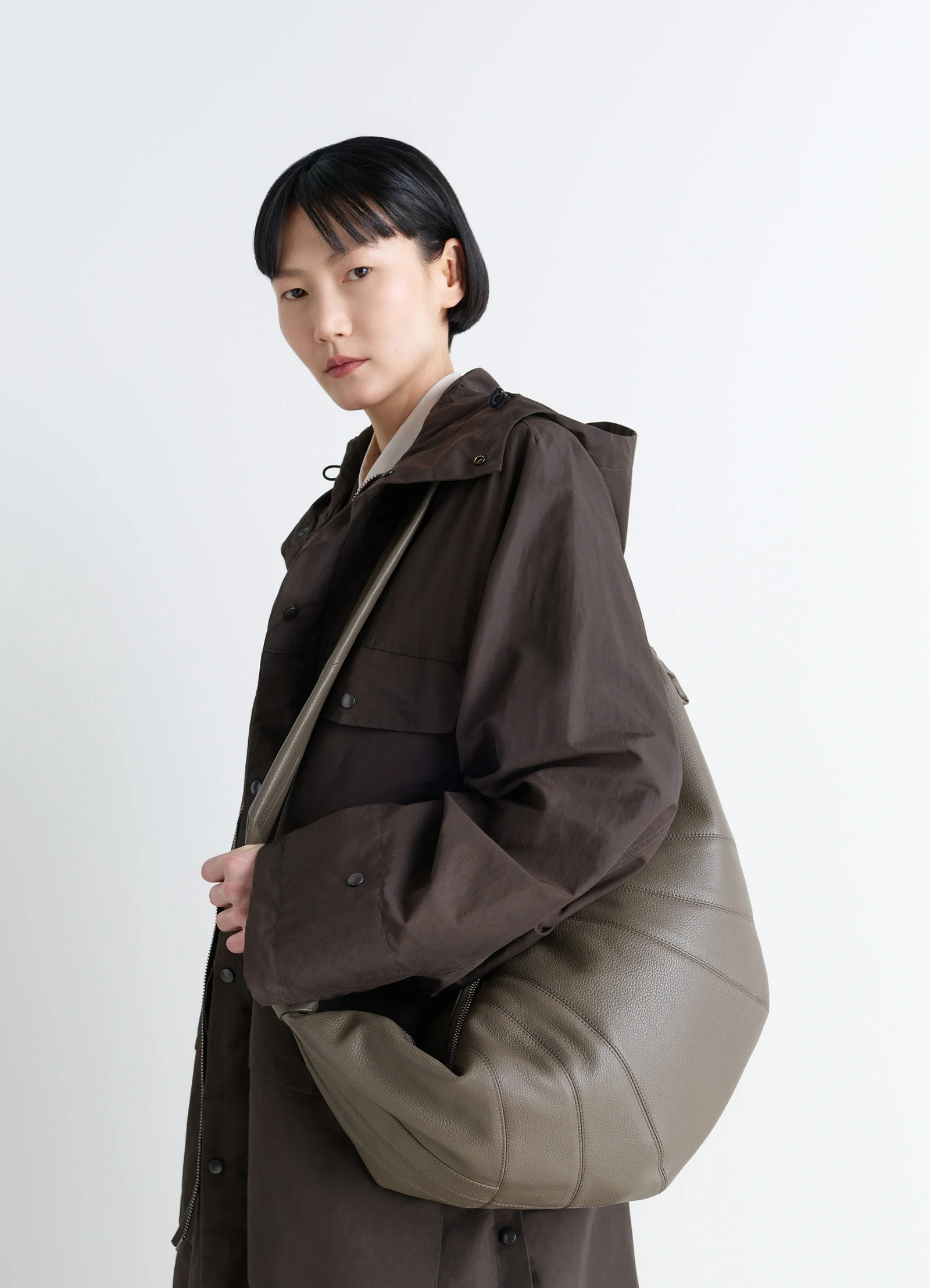 Lemaire large croissant bag in grained leather, model shot, side view curved design