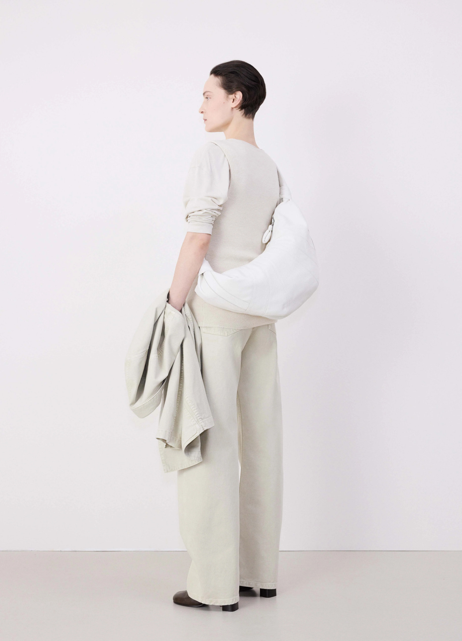 Lemaire large croissant bag in soft grained leather, model shot, back view curved drape detail