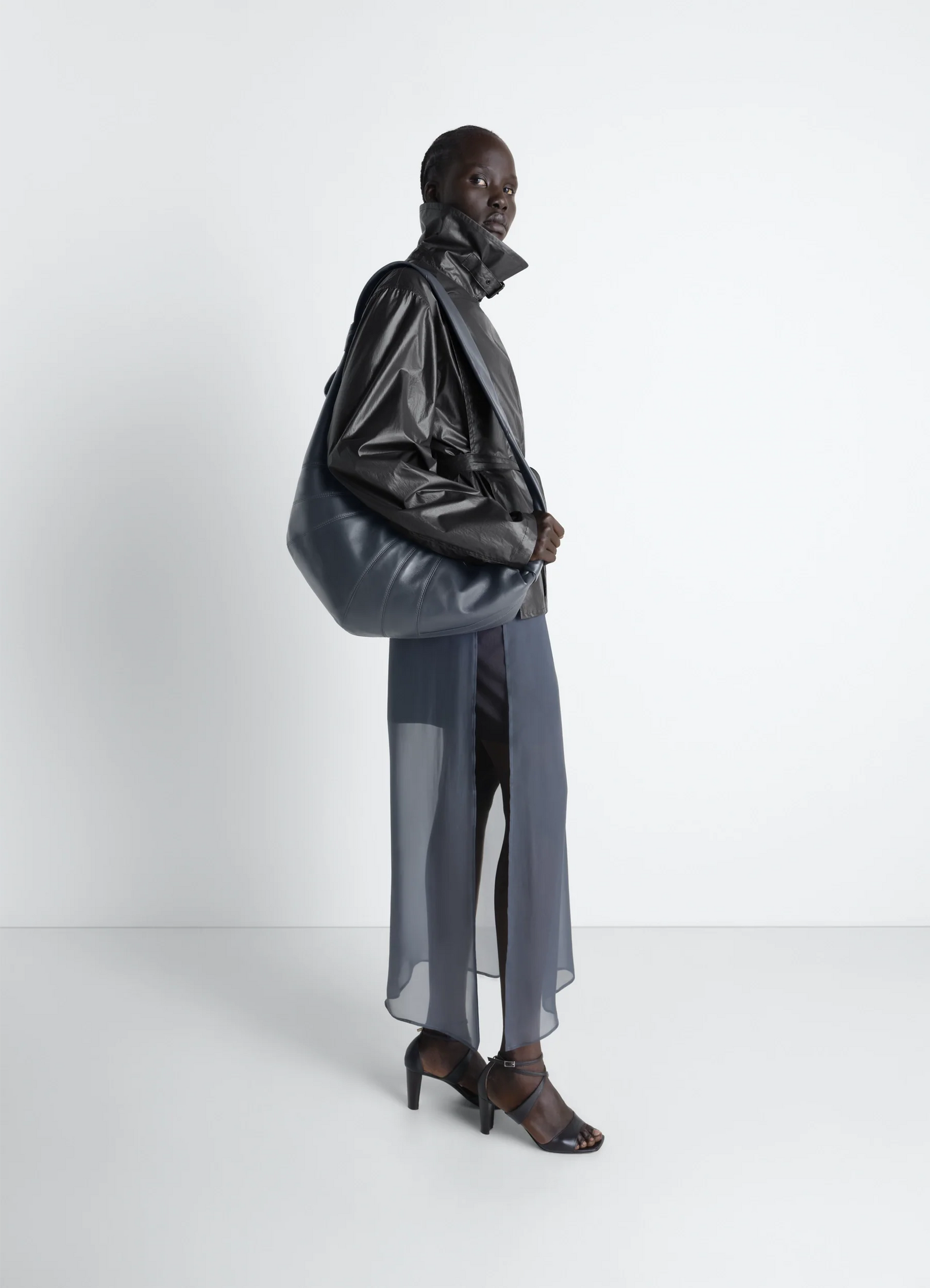 Lemaire large croissant bag in nappa lamb leather, model shot, side view slouchy shoulder style