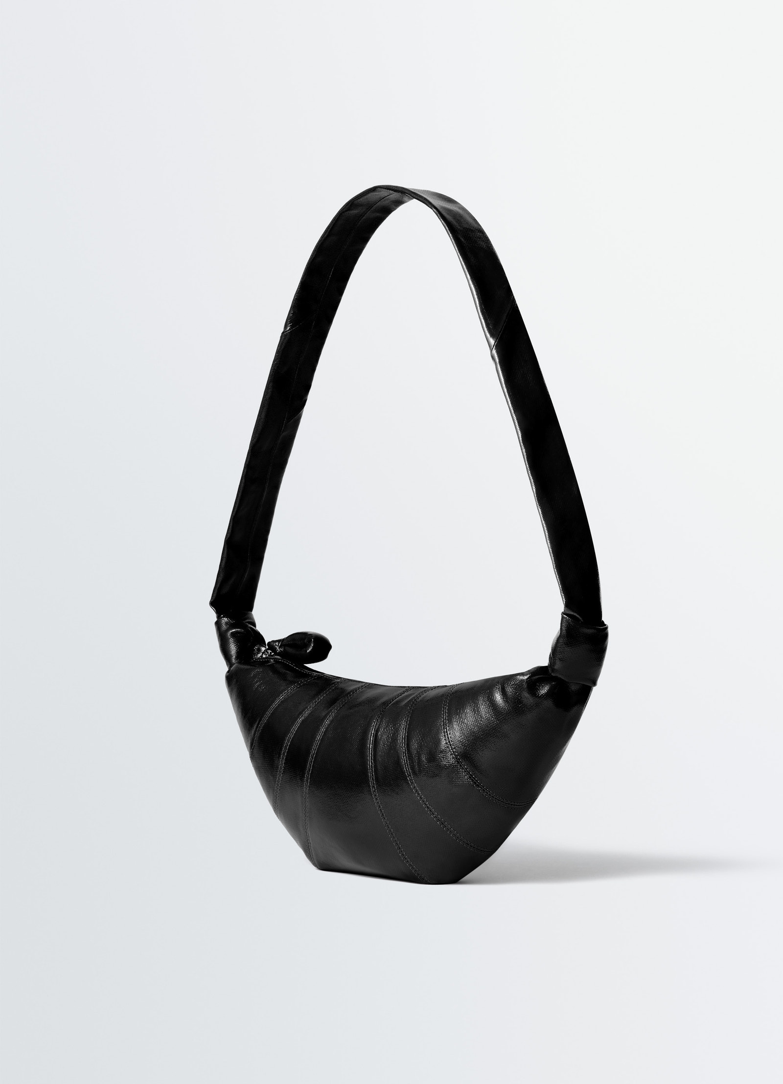 Medium croissant bag in coated cotton, product shot, side view arched handle detail