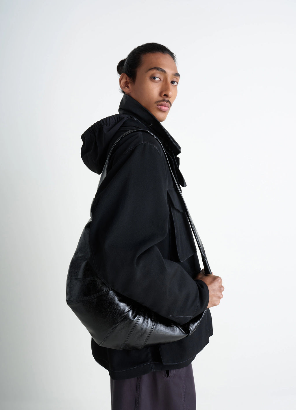 Lemaire Medium Croissant Bag in Black Coated Cotton, model shot, back view worn crossbody