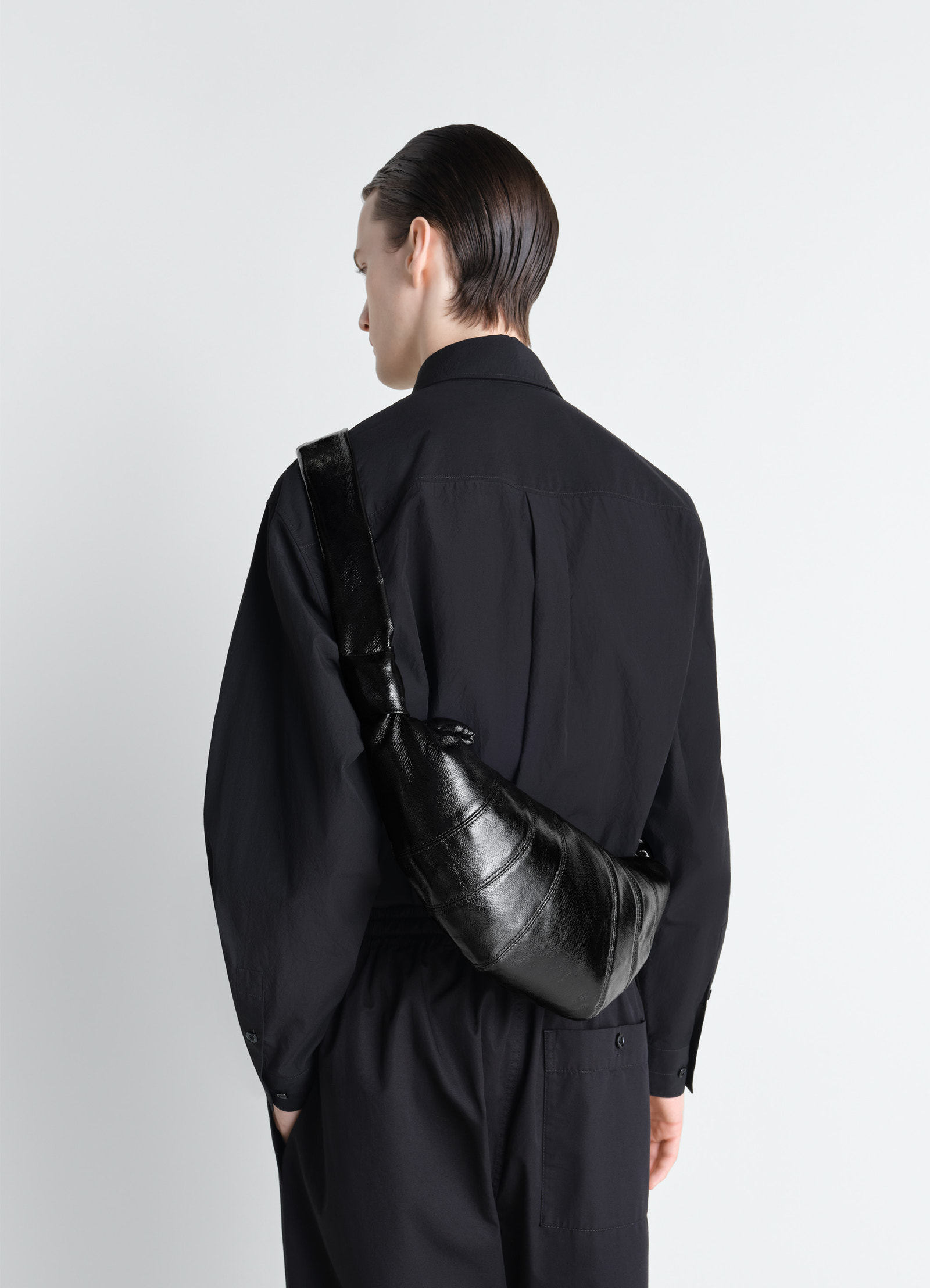 Medium croissant bag in coated cotton, model shot, over-the-shoulder textured finish