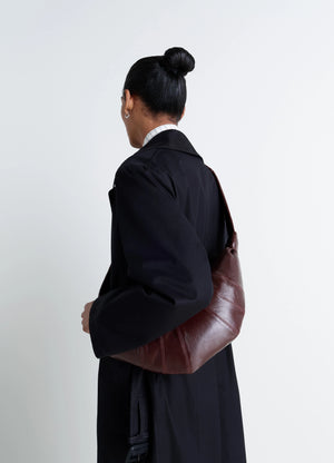 Lemaire Medium Croissant Bag in Brown Coated Cotton Canvas, model shot, Back view Curved shape