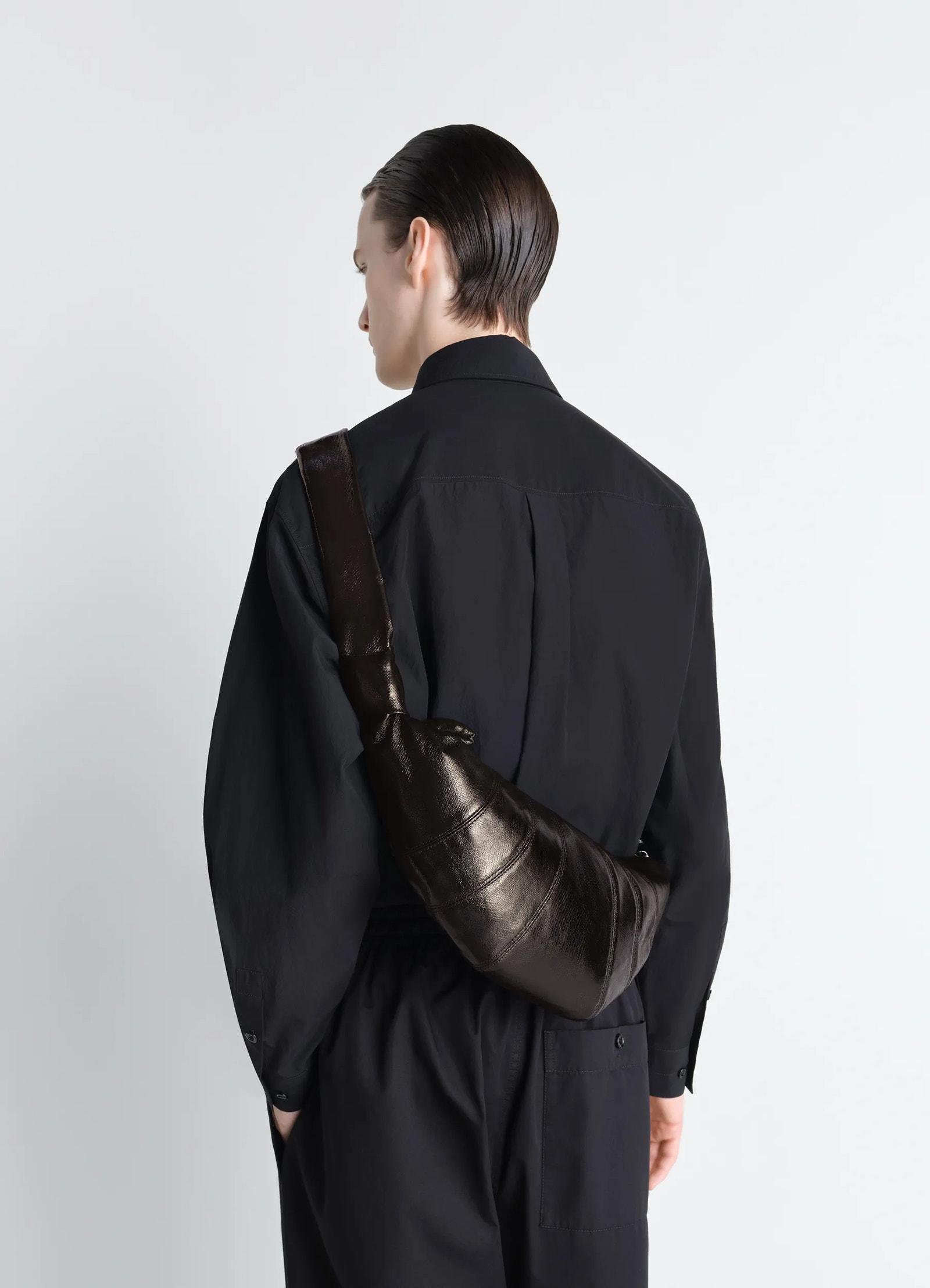 Medium croissant bag in coated cotton, model shot, side view crossbody worn